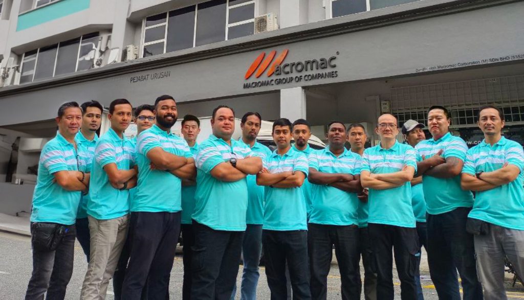 MACROMAC team in front of the office building